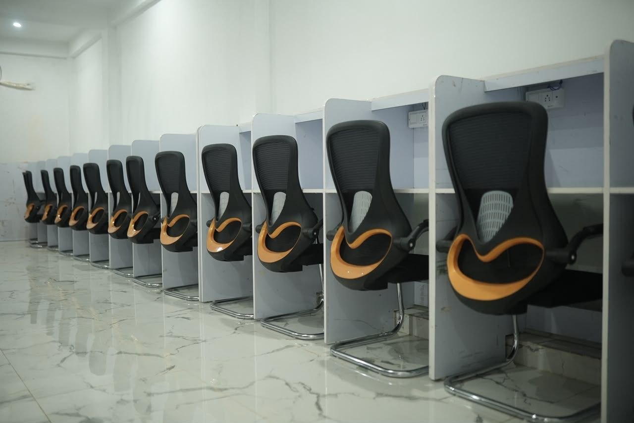 Partitioned desks with charging sockets and high-back chairs